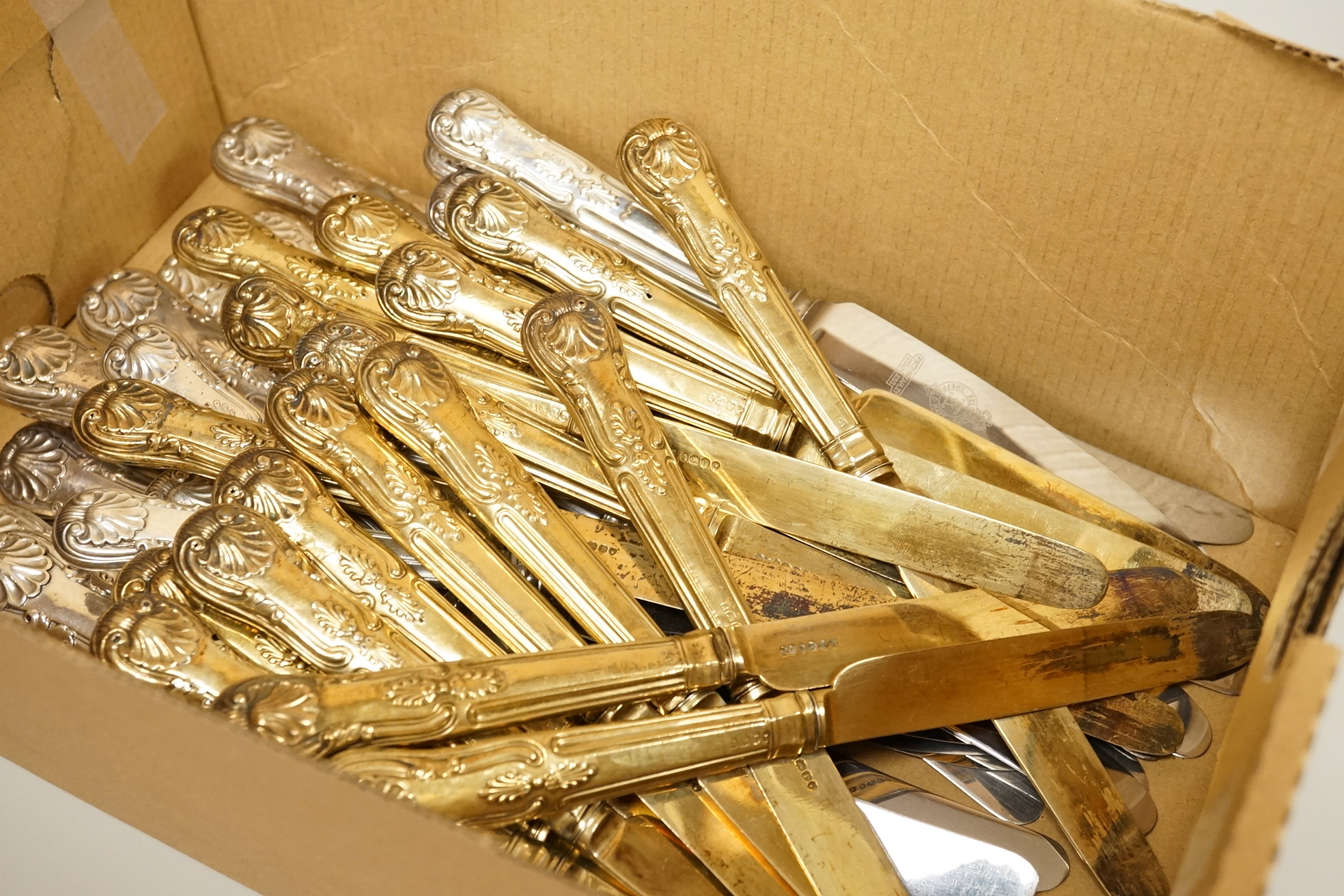 A set of eighteen William IV silver gilt King's pattern dessert knives, William Eaton, London, 1831/2, loaded handles, together with a set of twelve silver handled Kings pattern table knives and twelve matching dessert k